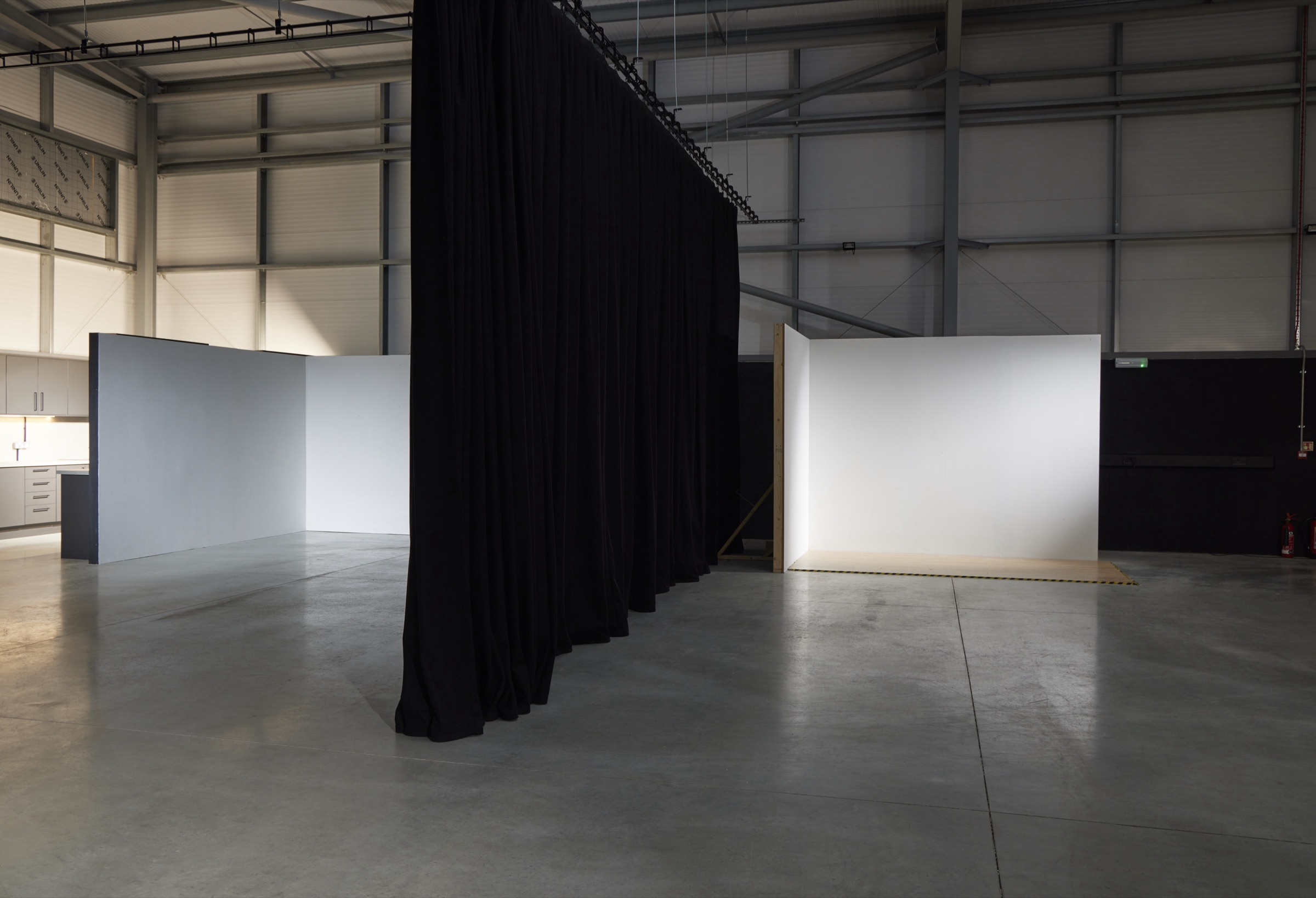 The full-height dividing curtain drawn across the studio
