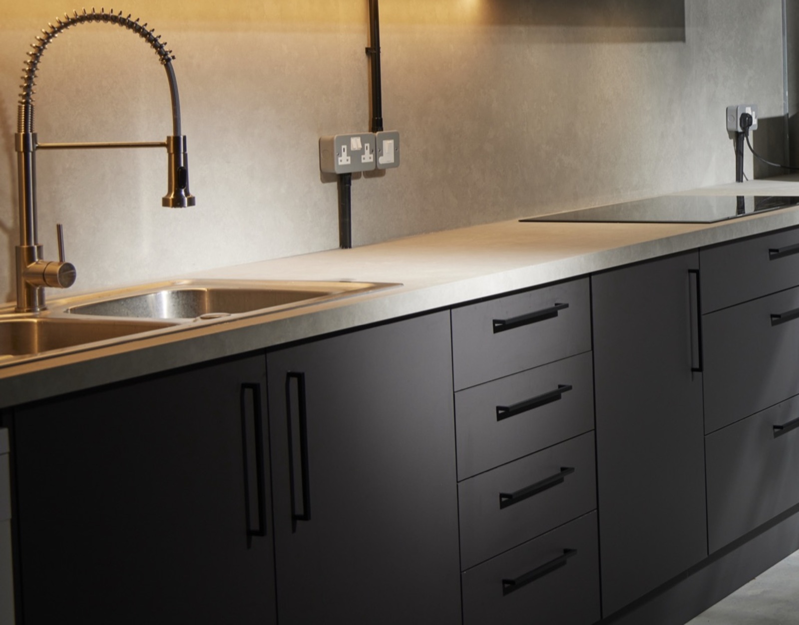 The prep run: twin sinks, pro spray tap and induction hob under the worktop lighting