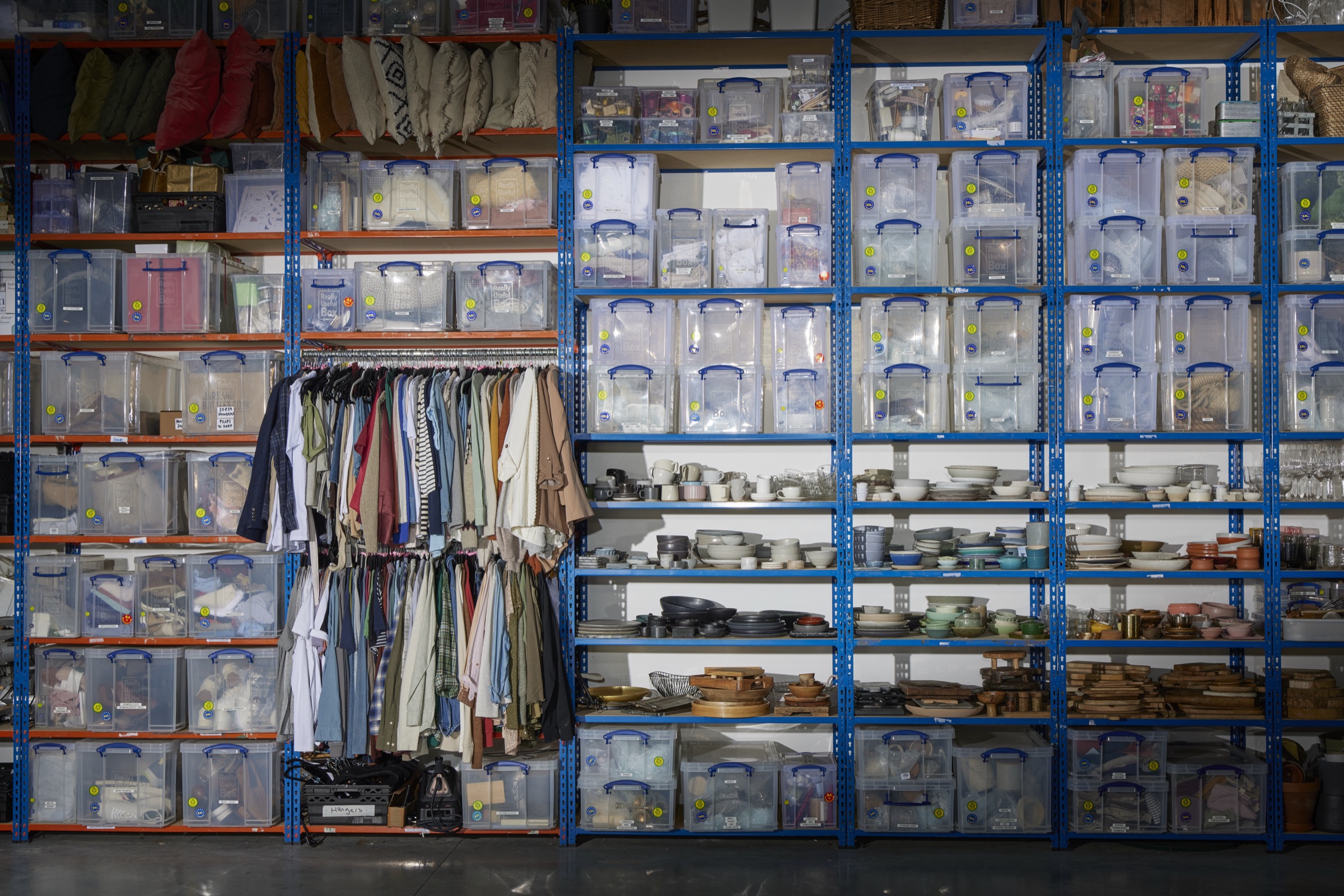 The props store: labelled crates, wardrobe rails and open shelving