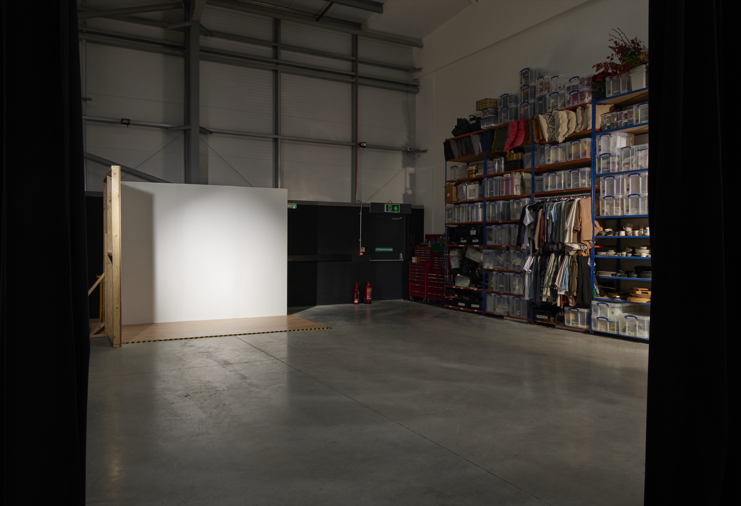 A white backdrop bay on the Hopclover Two shoot floor, beside the props store